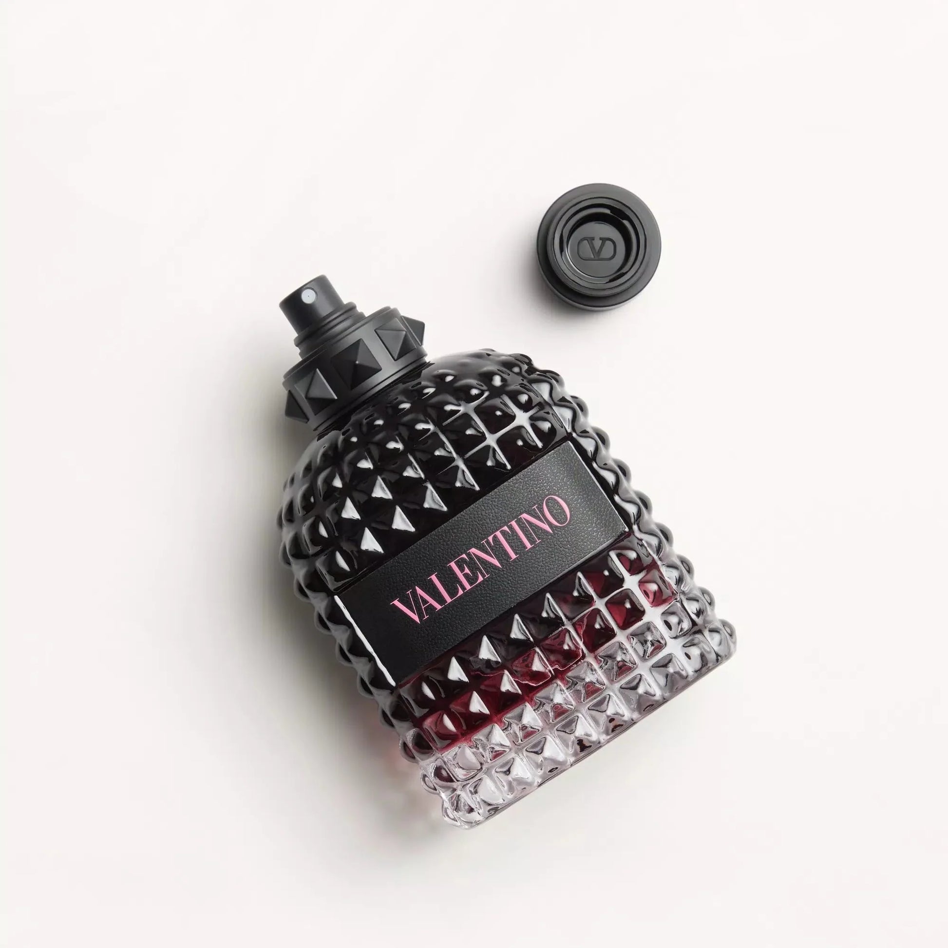 Valentino perfume bottle with black and red design on a white background